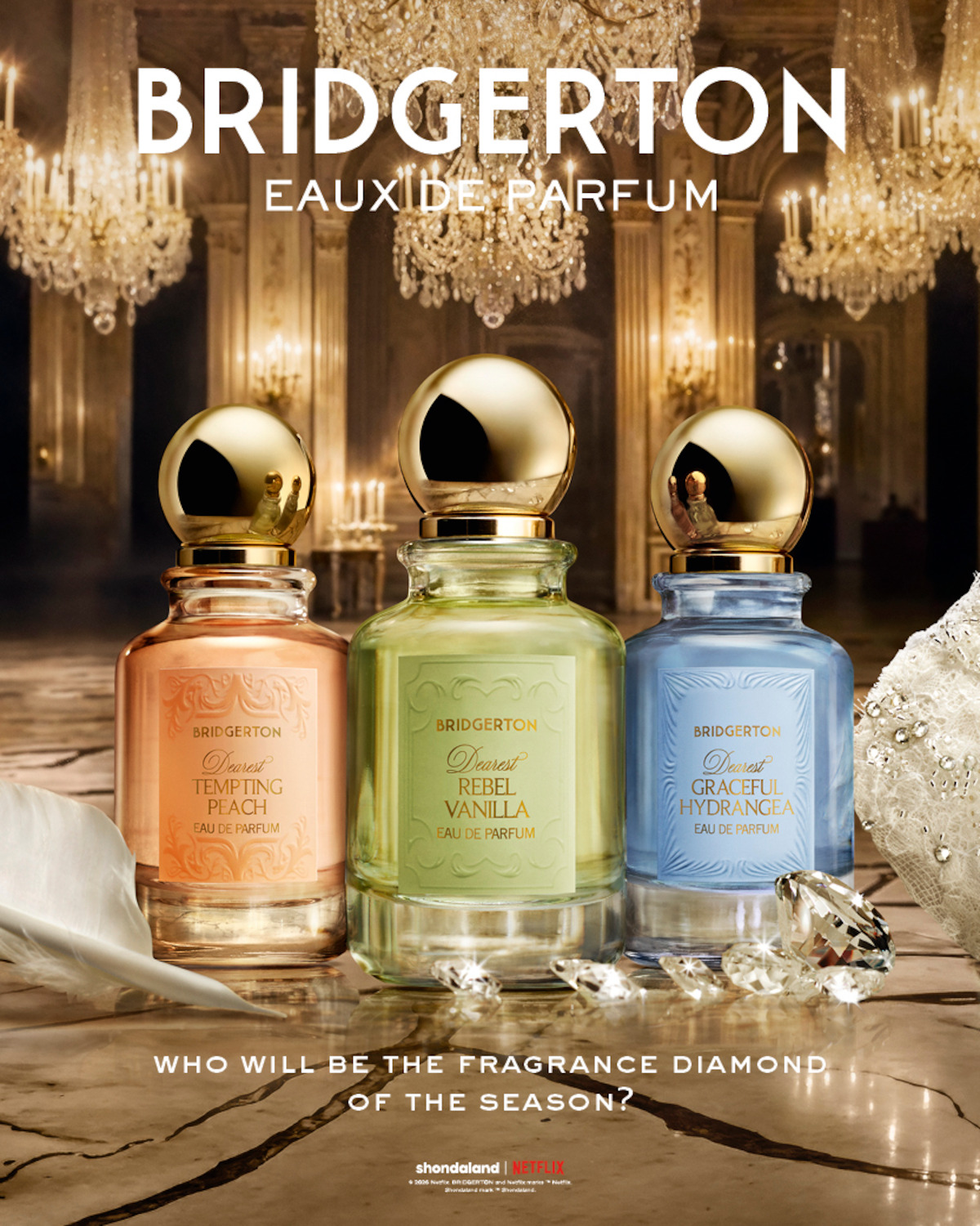 Three Bridgerton eau de parfum bottles (peach, gold, blue) displayed on a marble surface with diamonds in a lavish, chandelier-lit ballroom; elegant, luxurious setting with reflective surfaces.