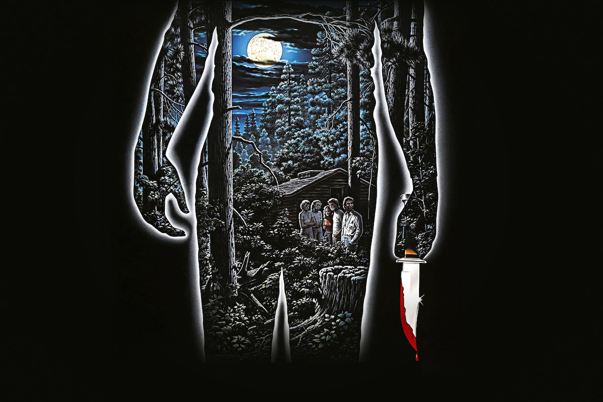 Silhouette of a person holding a bloody knife, framing a moonlit forest scene with a cabin and a group of people standing among trees at night.