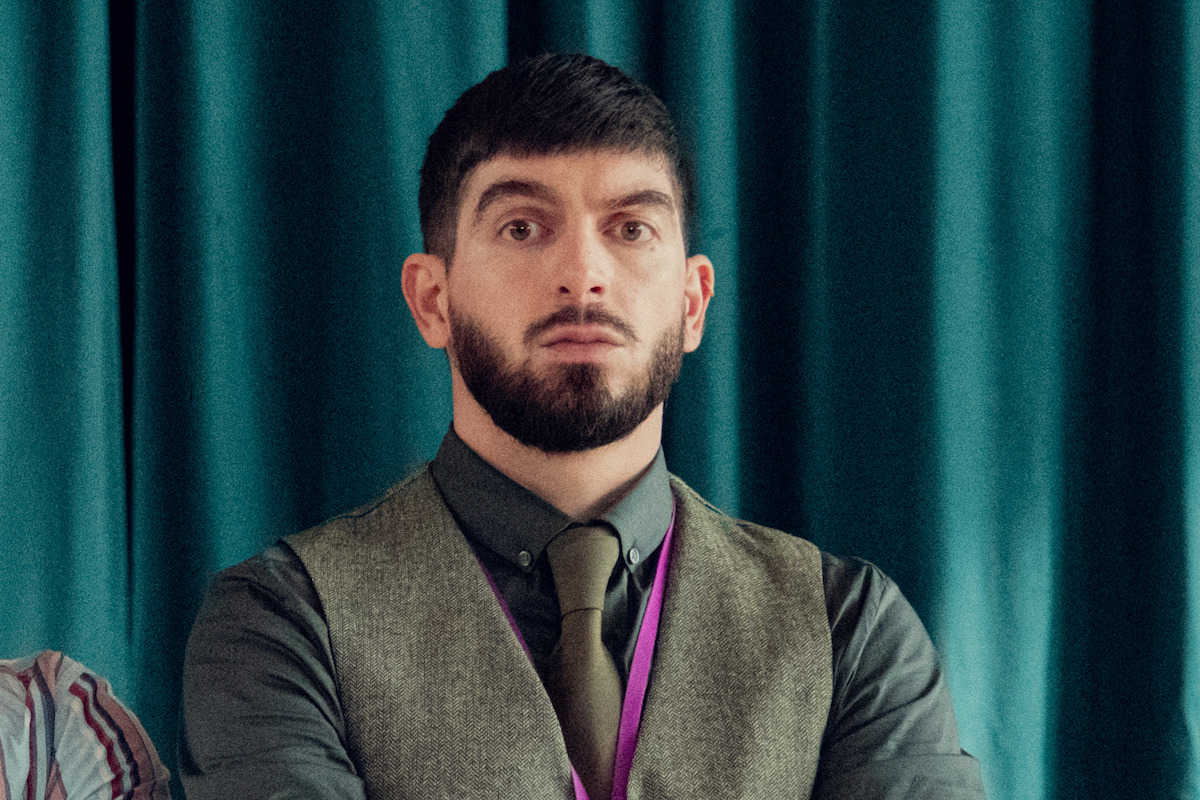 Nima Taleghani as Mr. Farouk stands with his arms folded alongside Fisayo Akinade as Mr. Ajayi in Season 2 of ‘Heartstopper.’