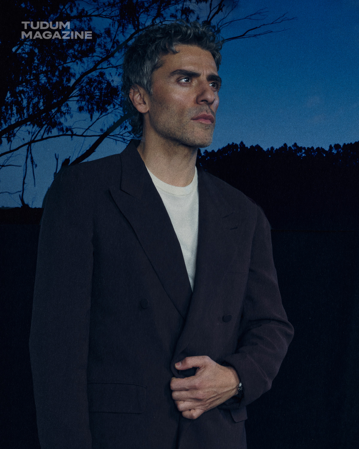 Oscar Isaac in a gray suit