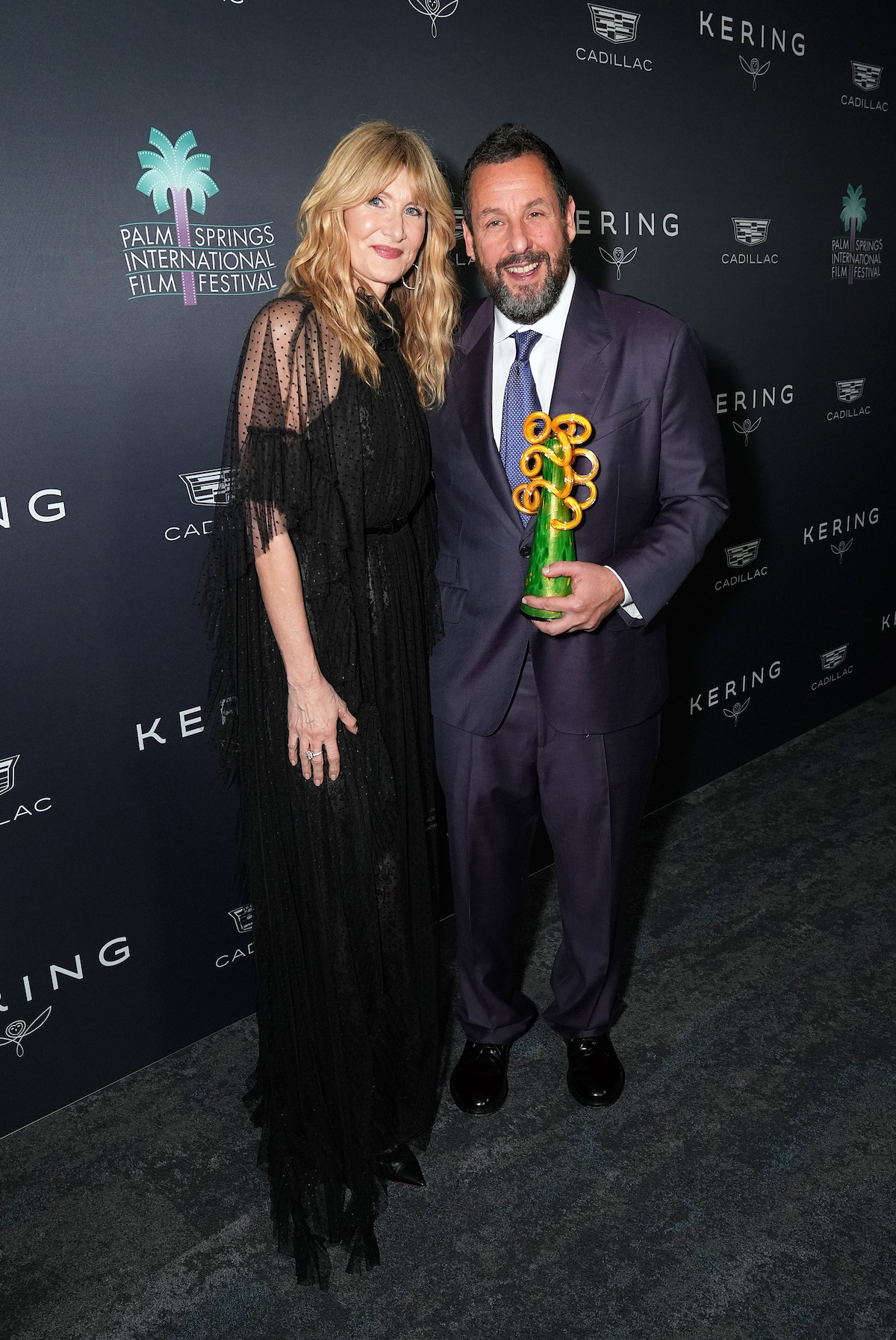 (L-R) Laura Dern and Adam Sandler, winner of the Chairman’s Award, attend the 37th Annual Palm Springs International Film Awards at Palm Springs Convention Center on January 03, 2026 in Palm Springs, California.