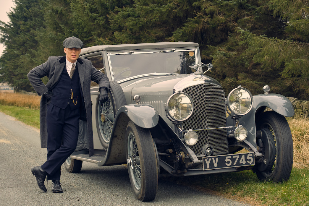 Tommy Shelby in three piece suit standing at his car on 'Peaky Blinders'