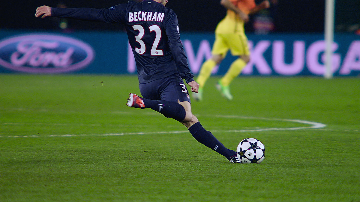 David Beckham kicks a ball while playing for Paris Saint-Germain Football Club.