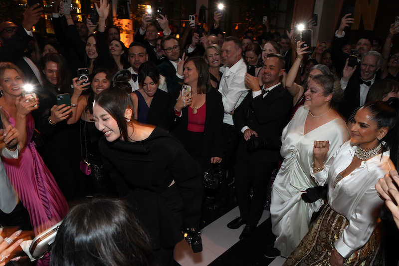 A crowd dancing on the dance floor. 