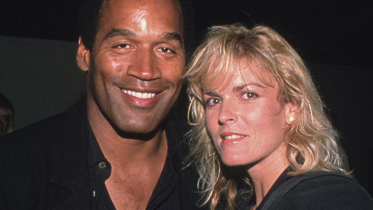 OJ Simpson and Nicole Brown Simpson smiling at the camera