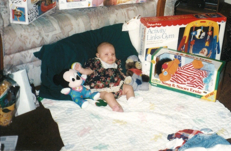 Hannah at Christmas, taken the year she received the “Sing and Snore Ernie” doll.