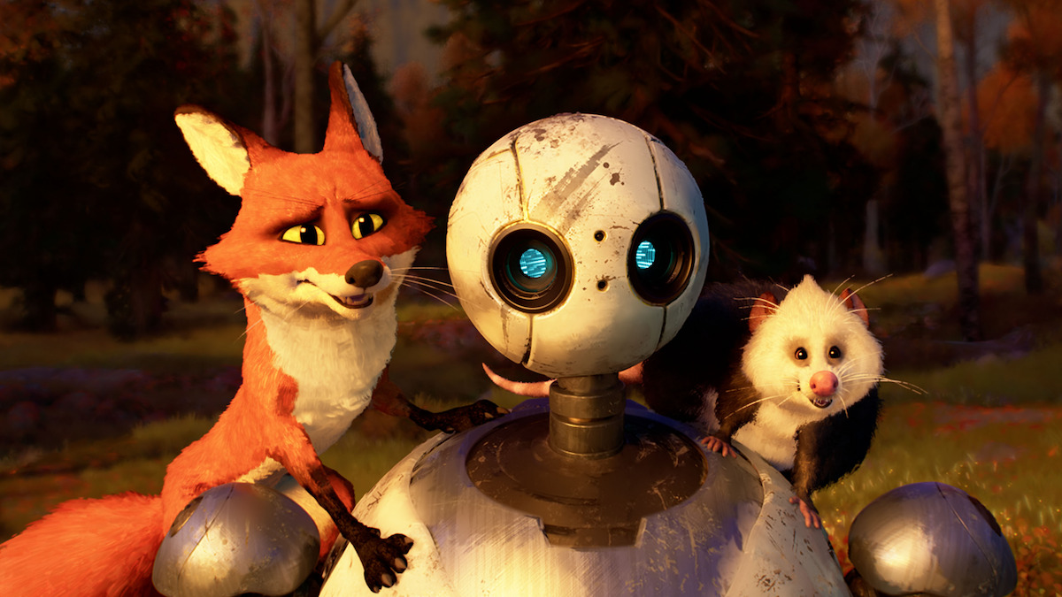 A still image from ‘The Wild Robot’ shows a fox and a possum on a robot’s shoulders as they look happily upon something in front of them.
