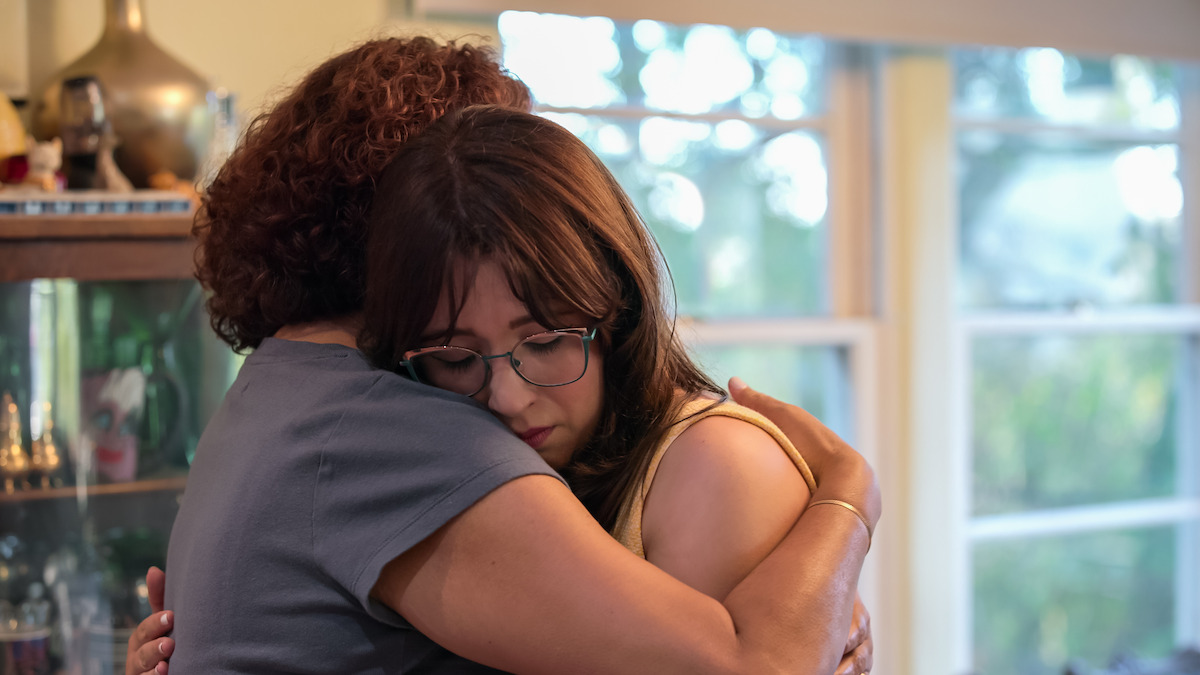 Dani is comforted by her mother.
