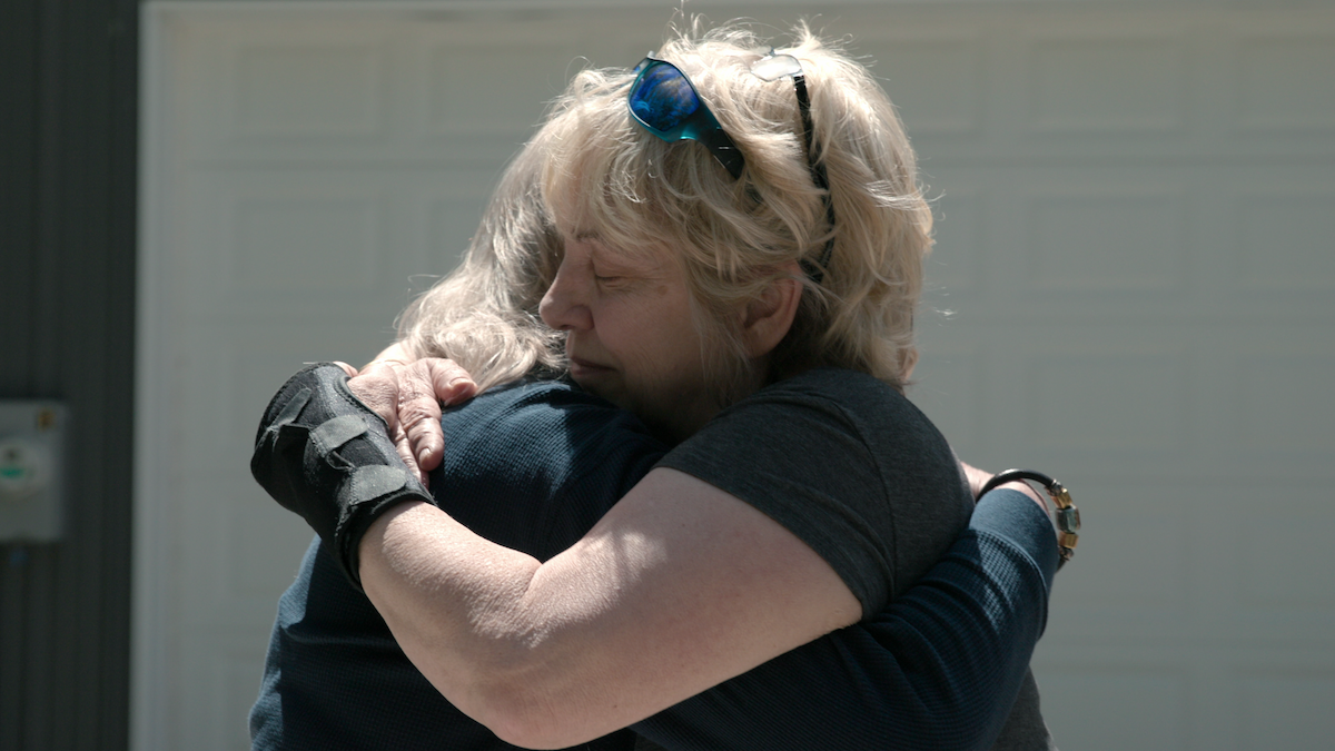 Cathy Terkanian embracing another person, whose face is not shown.