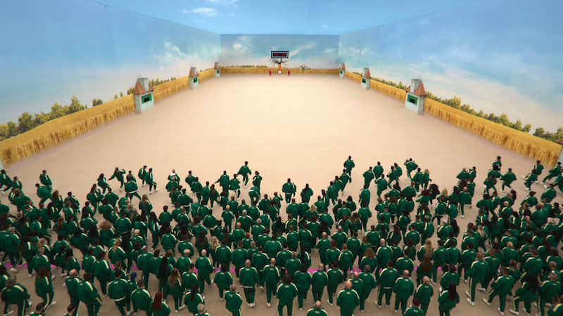 A group of men and women wearing green jumpsuits in the The Challenge