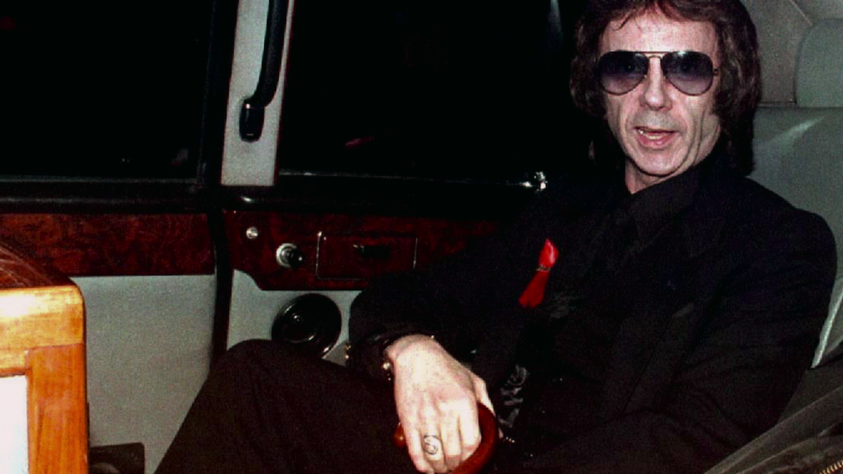 Phil Spector sitting in a limousine.