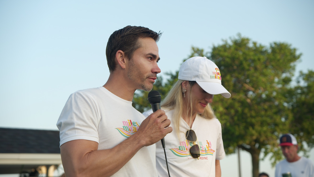 Camilo Villegas speaks into a microphone with Maria Ochoa next to him.