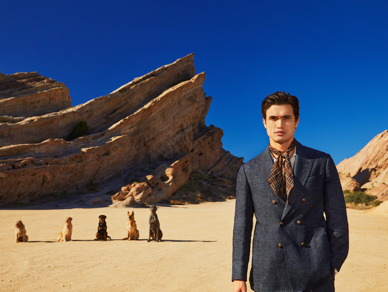 Charles Melton poses with dogs.