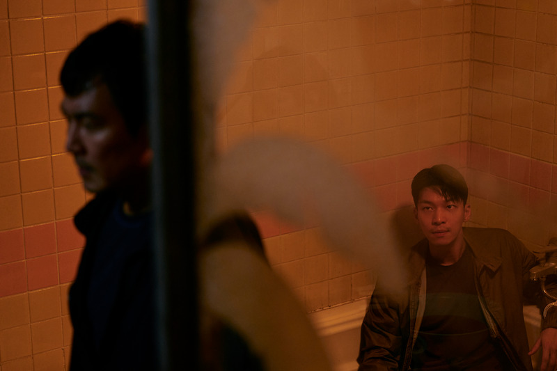 A man handcuffed in to a faucet sits in a bath tub Season 2 of 'Squid Game'