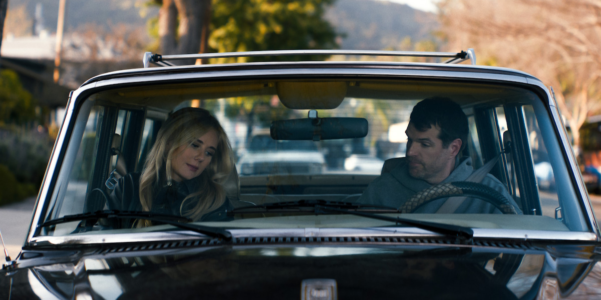 Justine Lupe as Morgan and Timothy Simons as Sasha sit in a car together in Season 1 of ‘Nobody Wants This’