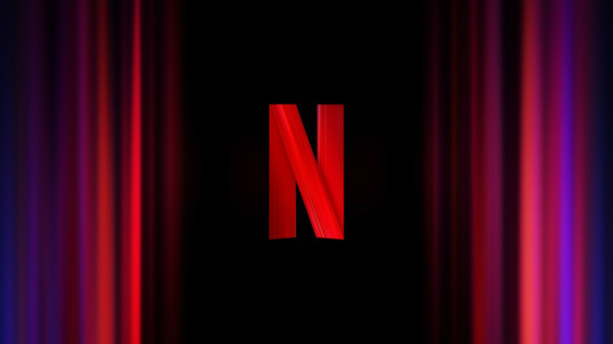 Red Netflix logo centered on a black background with dimly lit vertical red and purple streaks on the sides, creating a dramatic and cinematic mood.