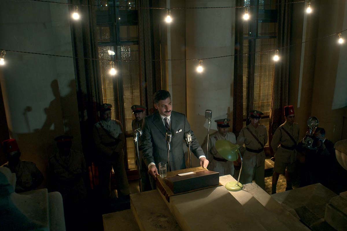 a man standing behind a podium and microphone