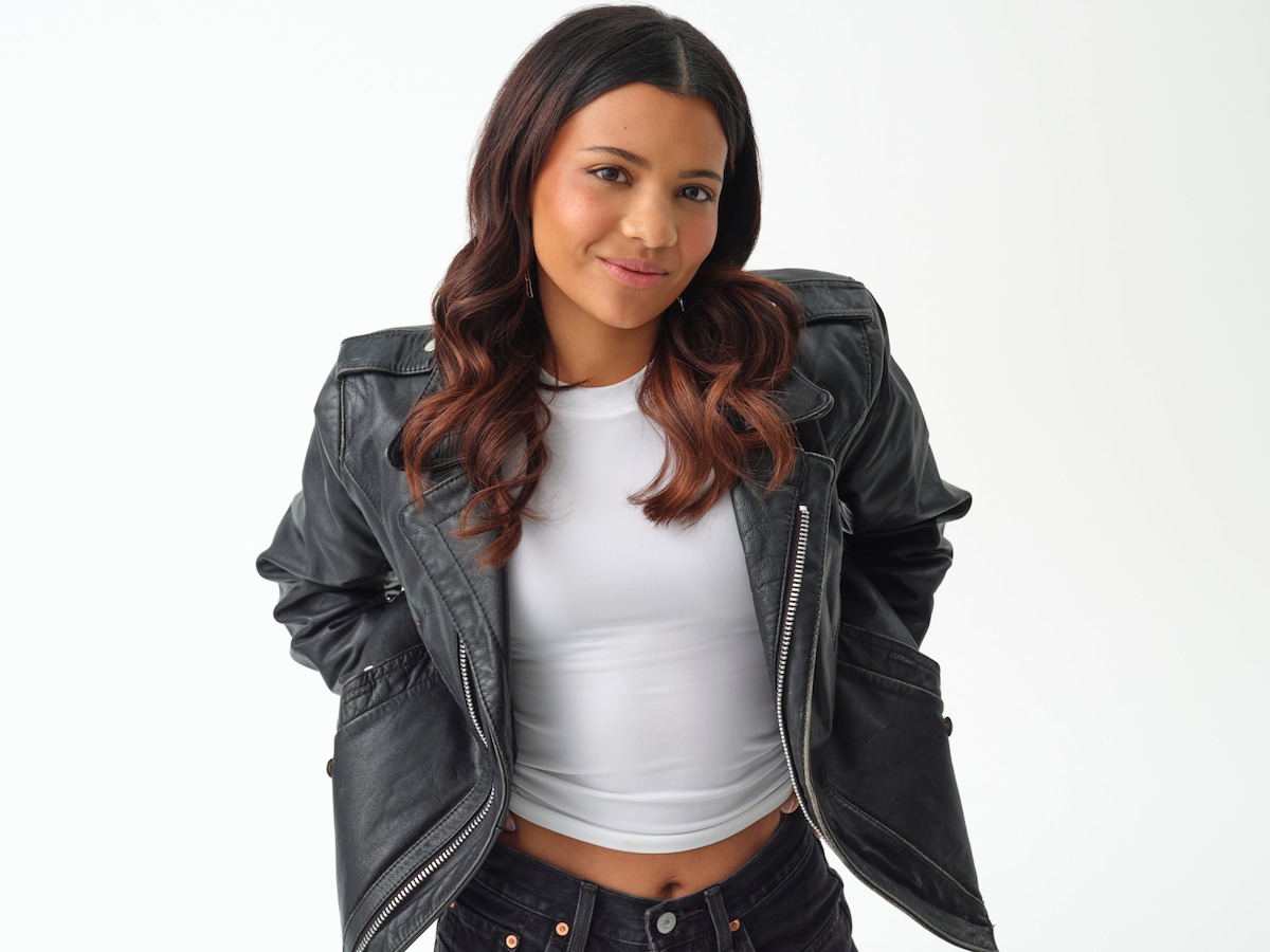 Nikki Rodriguez wears a black leather jacket in a studio for ‘My Life with the Walter Boys’