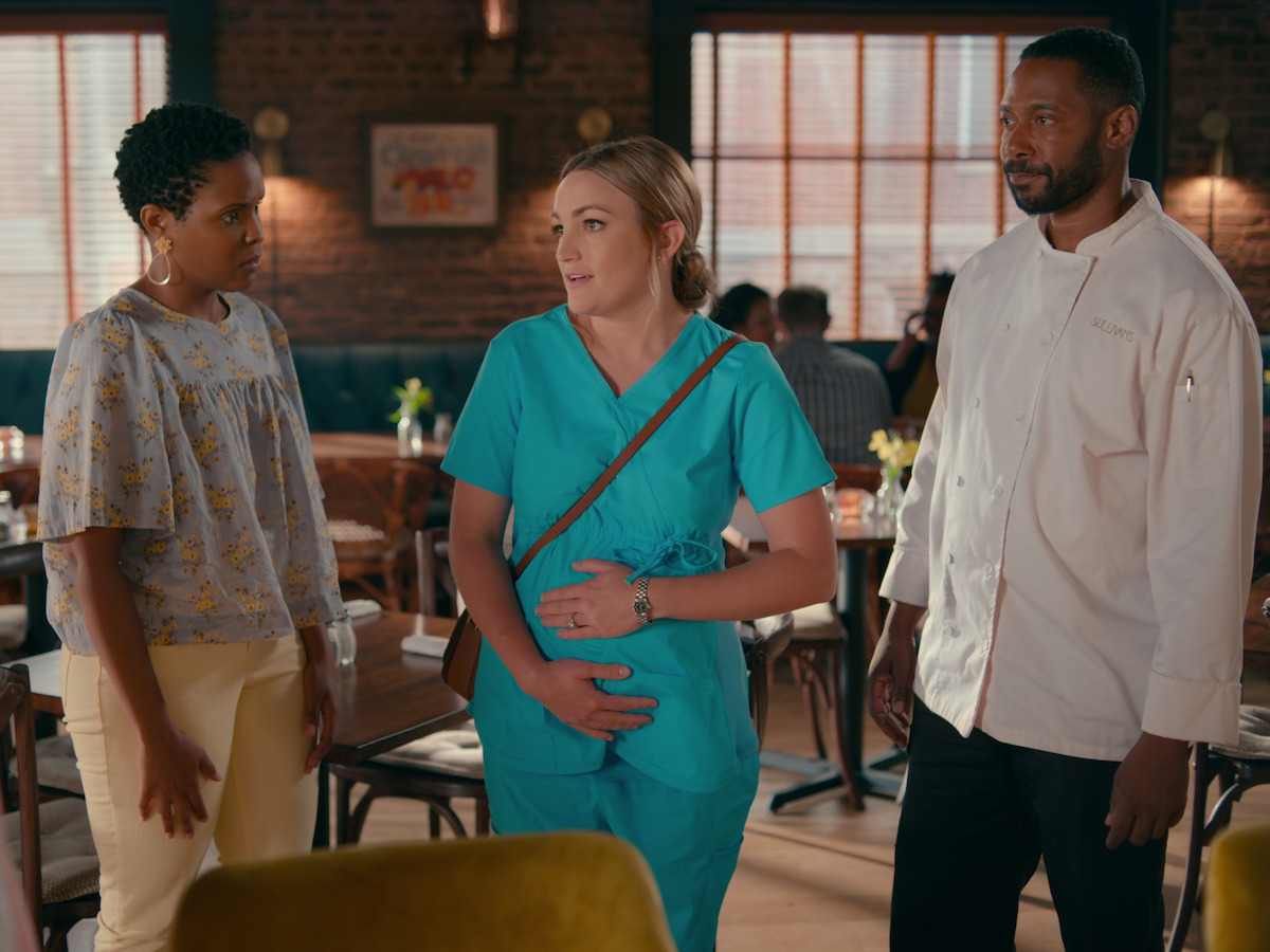 Three people standing in a room