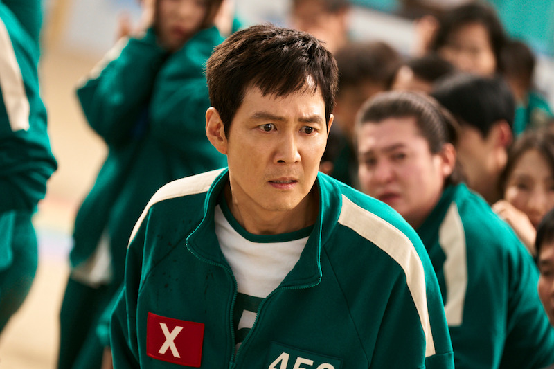 Jung-jae as Seong Gi-hun wears a green track suit and shows a concerned expression in Season 2 of 'Squid Game'
