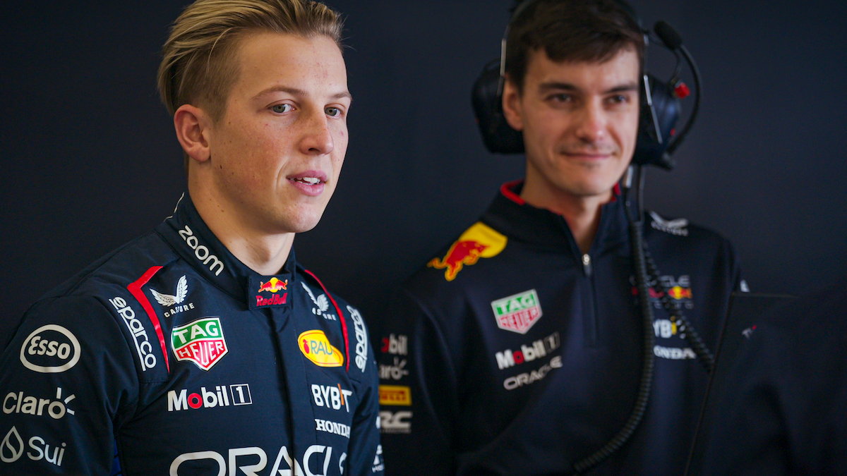 Liam Lawson with a crew member.