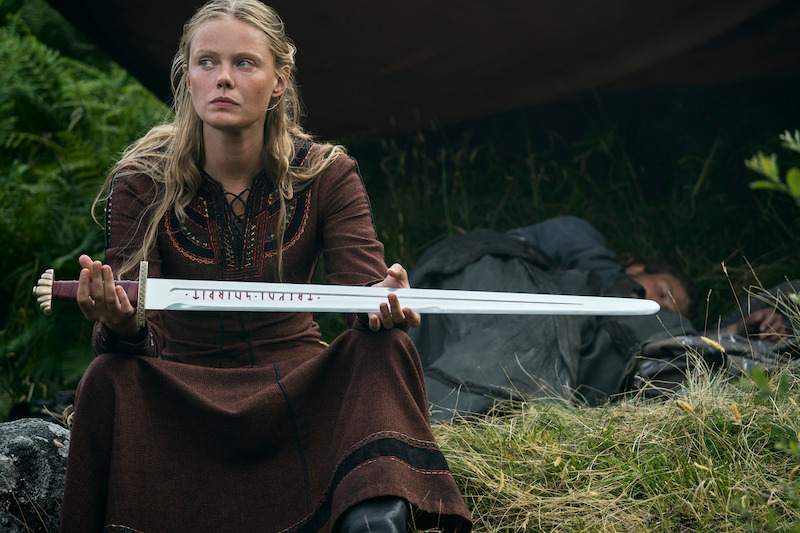 Freydis (Frida Gustavsson) brandishes her sacred sword. 