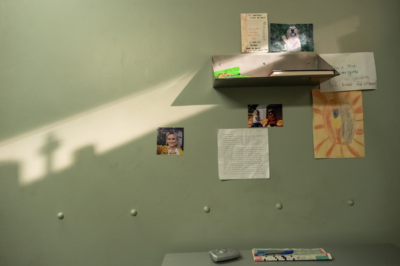 Prison cell wall decorated with drawings and photographs in Season 7 of Orange Is the New Black. 