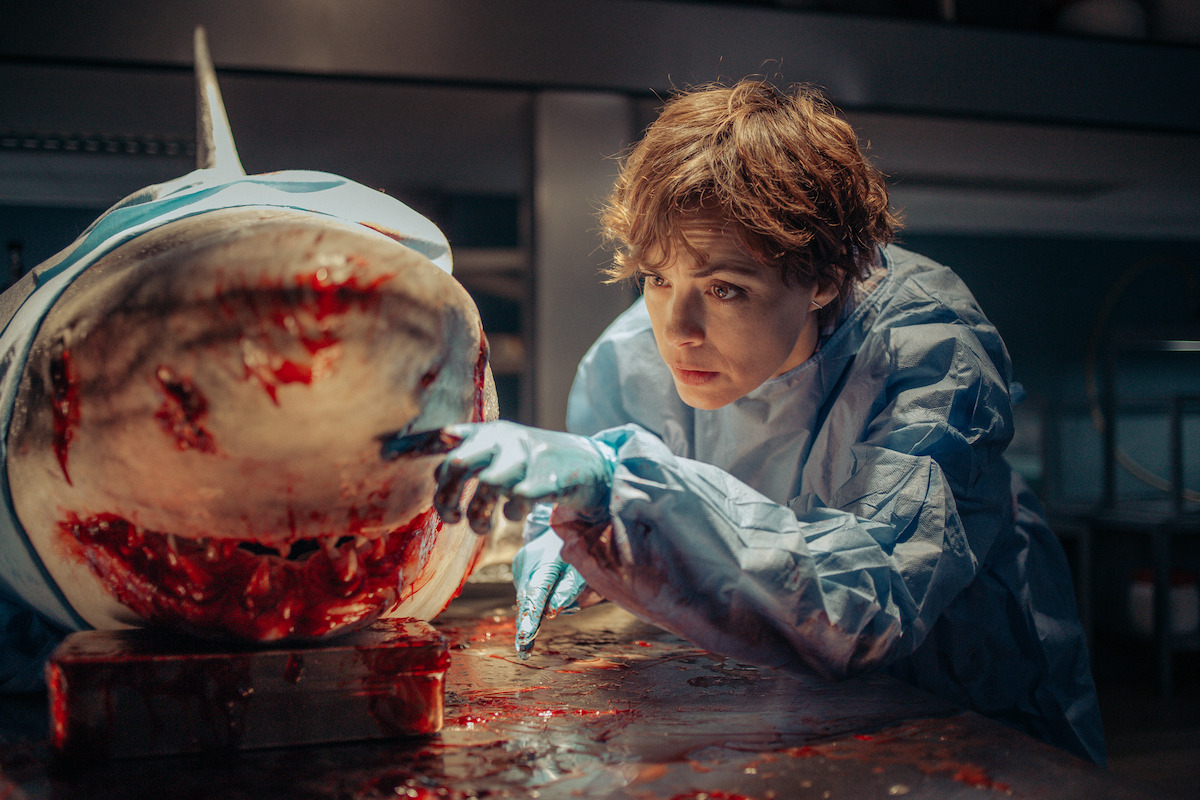 Bérénice Bejo as Sophia Assalas investigates a dead shark in an image from the thriller ‘Under Paris.’