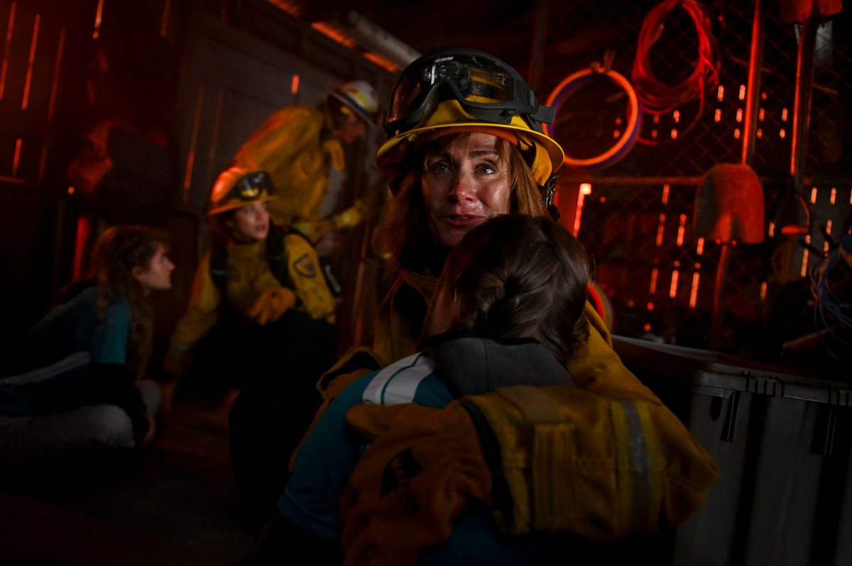 Diane Farr as Sharon Leone comforting a teenager she rescued.