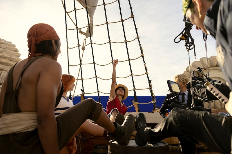 Iñaki Godoy as Monkey D. Luffy putting his fist in the air on set of Season 1 of 'One Piece.'