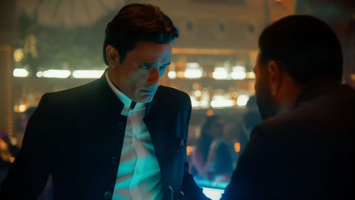 Akshaye Khanna as Shauryaman Gaur stares down Sunny Deol as Arjun Mehra at a bar in ‘Ikka.’