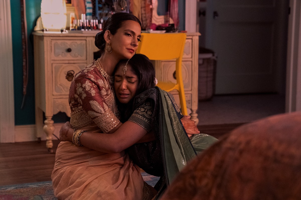 Poorna Jagannathan as Nalini Vishwakumar and Maitreyi Ramakrishnan as Devi embracing in ‘Never Have I Ever’ Season 4. 