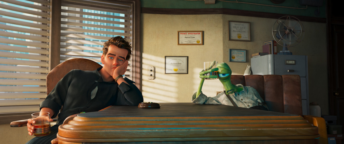 Animated man and lizard wearing a shirt sitting at a desk in an office with certificates on the wall, blinds on the window, and a fan on top of a filing cabinet in the background.
