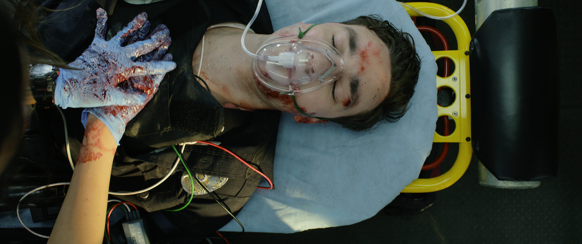 Jackson White as Officer Zach Parker bleeds out in the back of the titular ambulance.
