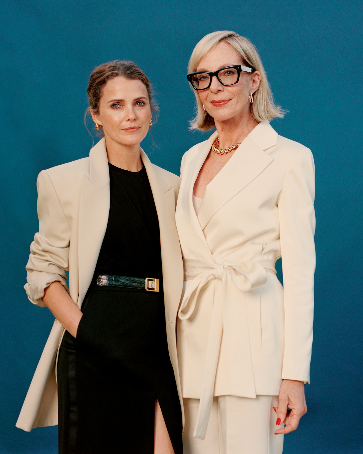 Keri Russell and Allison Janney standing together in front of a blue backdrop.