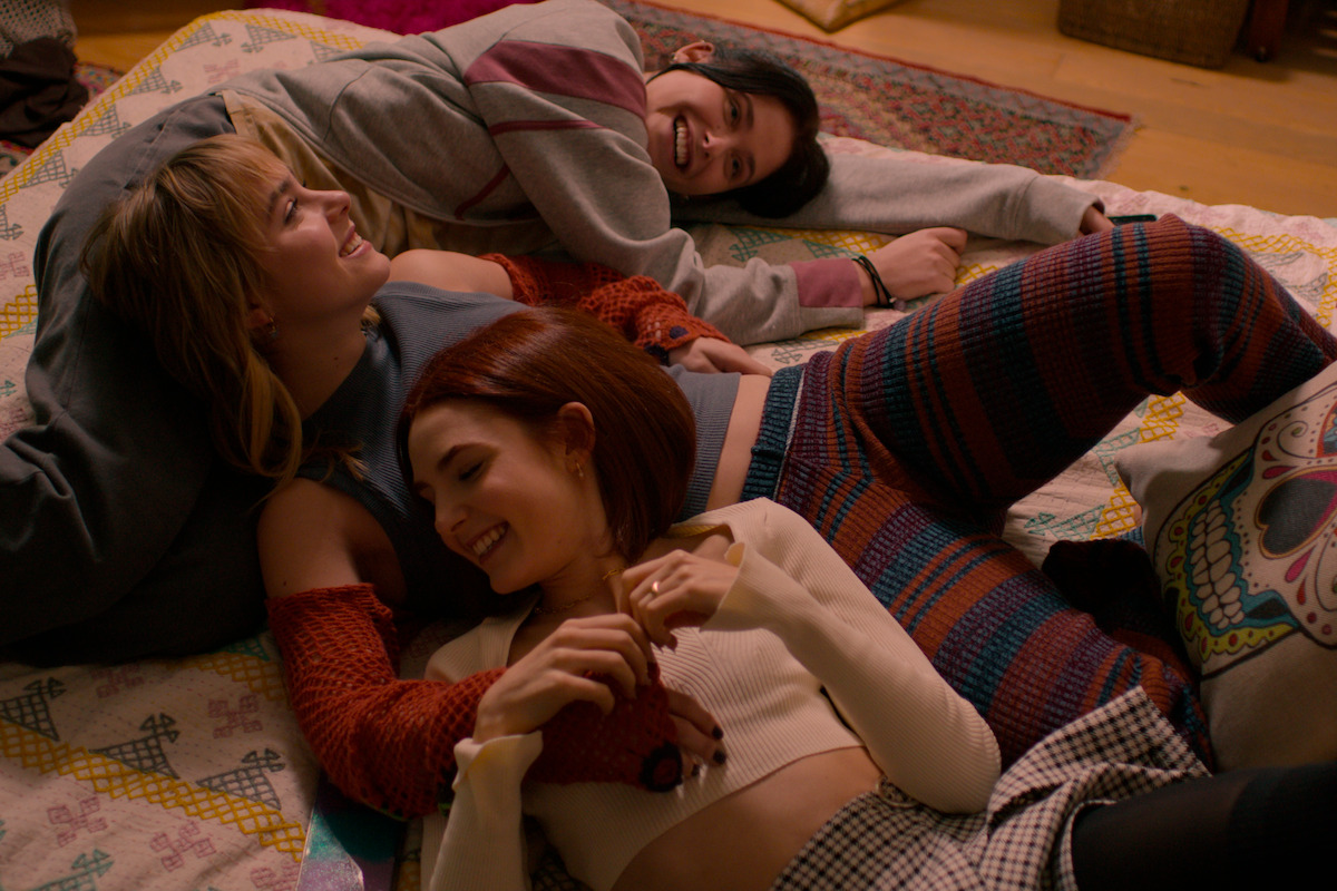 In an image from the series ‘Raising Voices,’ Nicole Wallace as Alma, Clara Galle as Greta, and Aïcha Villaverde as Nata cuddle on the floor.
