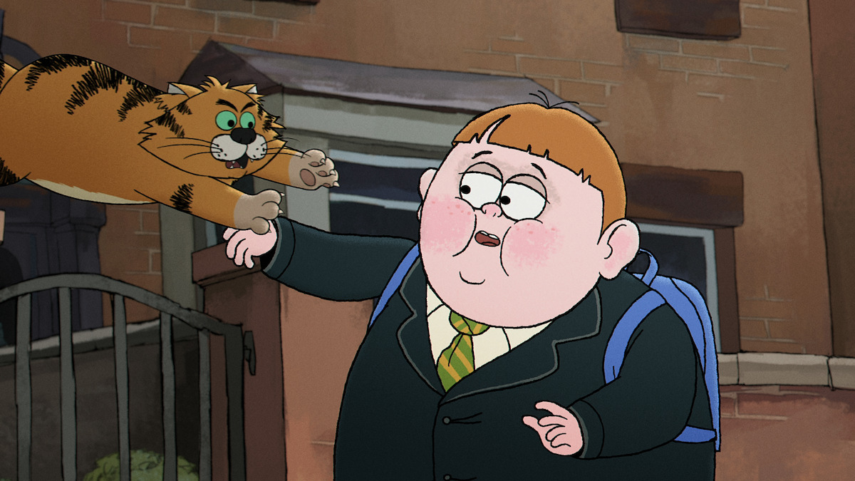 Animated boy in a school uniform with backpack startled as a leaping cartoon cat reaches for his arm, set outside in front of a brick building and wrought iron fence.