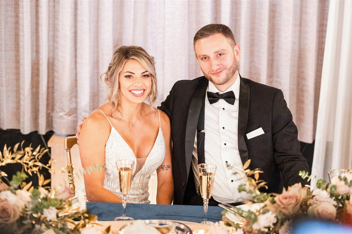 Madison and Allen pose at the sweethearts table on their wedding day in ‘Married at First Sight.’