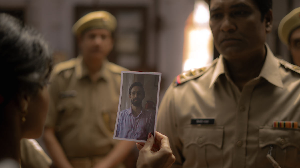 Bhumika Dube as Poonam shows Aditya Srivastava as Kishore a picture of Vikrant Massey as Rishu in an image from the film ‘Phir Aayi Hasseen Dillruba.’
