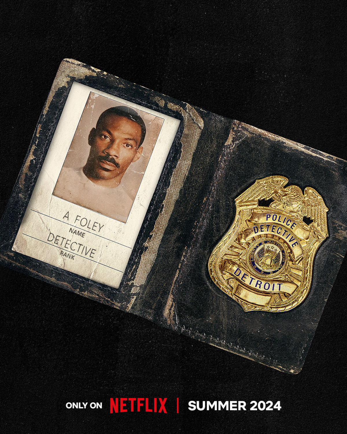 A battered wallet with a Detroit police detective badge and a photo ID bearing Eddie Murphy’s face and the name “A Foley” under the words “Person of Interest: If you have any information, please contact the Beverly Hills Police Dept.