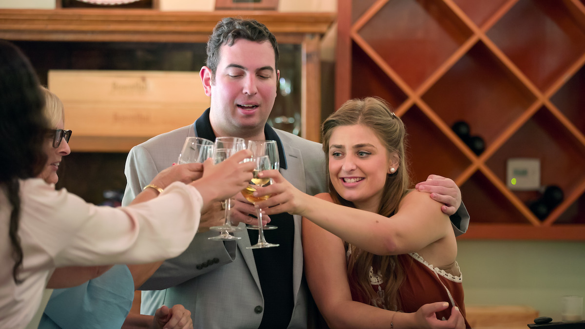 David and Abbey clinking glasses.