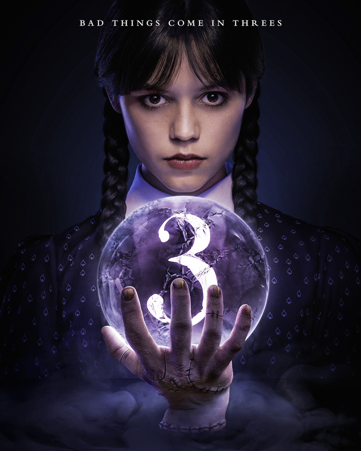Wednesday Addams and Thing, holding a crystal ball with the number “3” inside of it in.
