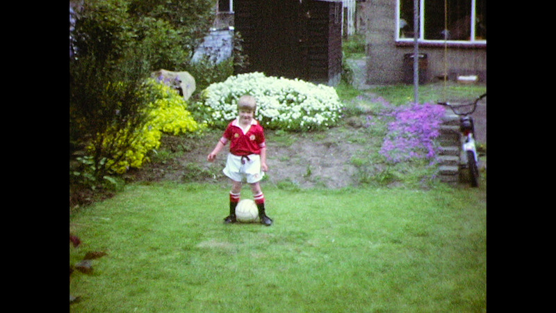 A young David Beckham playing soccer in the garden