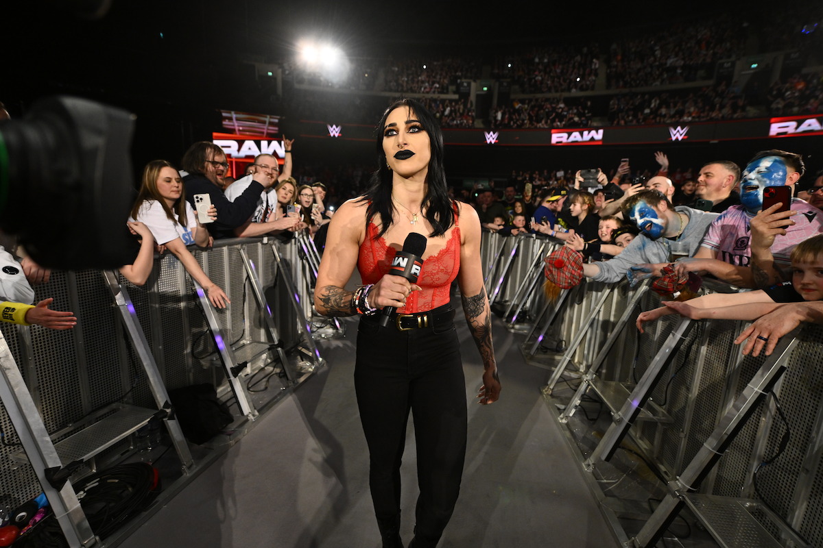 Rhea Ripley enters the arena holding a mic