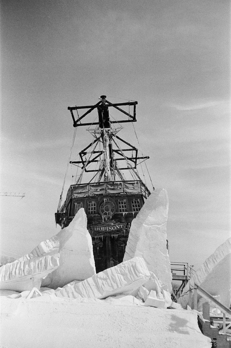 A black-and-white image of a ship coming out of fake ice.