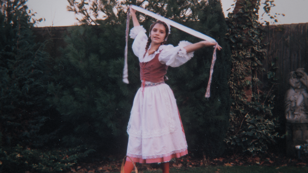 Victoria Beckham as a child in a dance costume posing.