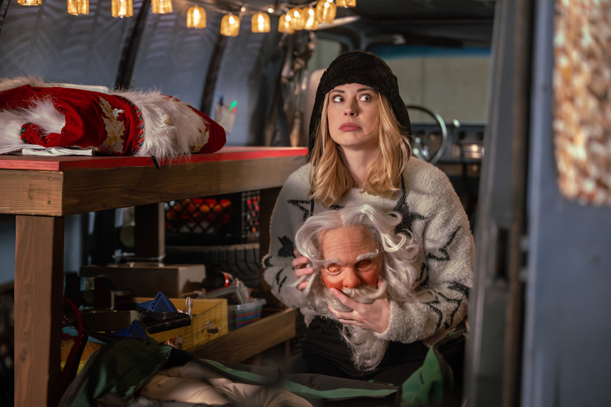 Alexandra Breckenridge as Taylor holds a Santa mask in ‘My Secret Santa.’