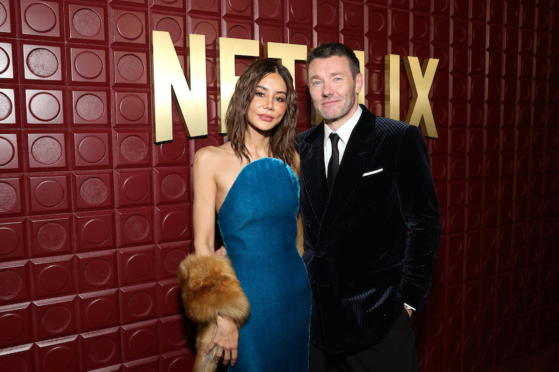 Christine Centenera and Joel Edgerton stand in front of a red backdrop.