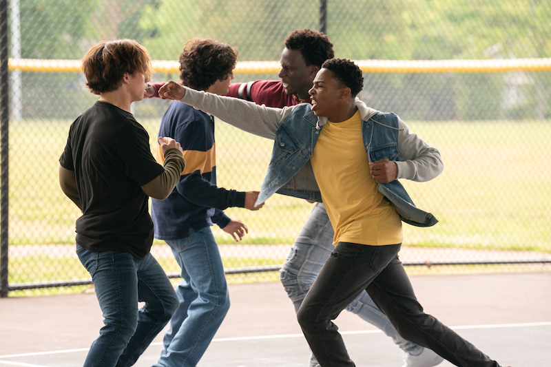 Tanner Buchanan as Robby Keene, Xolo Maridueña as Miguel Diaz, Okea Eme-Akwari as Shawn, and Dallas Dupree Young as Kenny fight each other in Season 6 of 'Cobra Kai.'