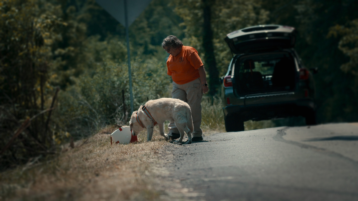 K9 handler Cindy Braden and her dog examining a cooler.